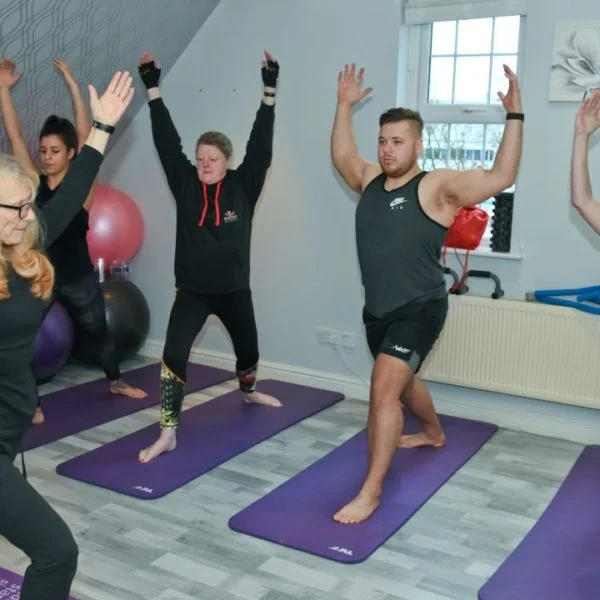 A group class stretching on mats