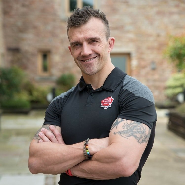 Daniel Masters, owner of Masters Fitness, arms folded outside the studio