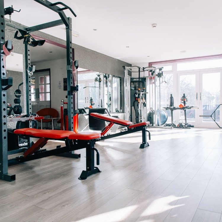The private Masters Fitness training studio with a power rack and red bench