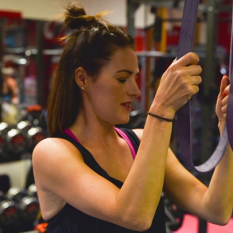A Masters Fitness client stretching with a resistance band