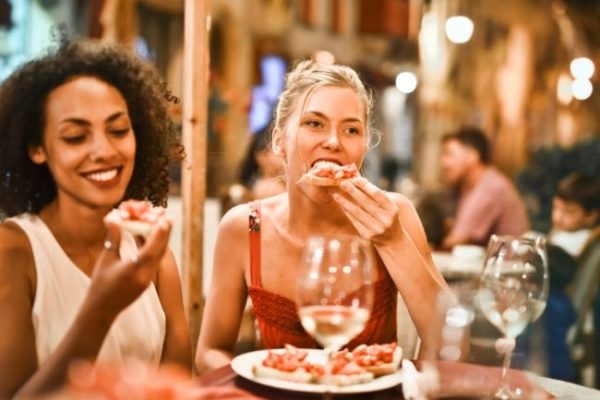 Two friends eating out at a restaurant