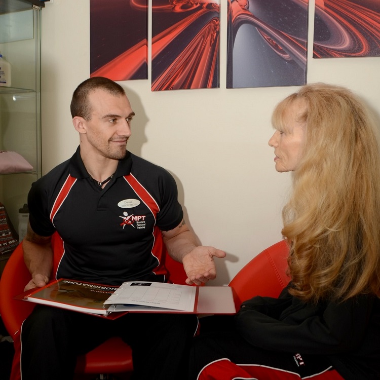 A Masters Fitness coach talking through a lifestyle questionnaire with a client