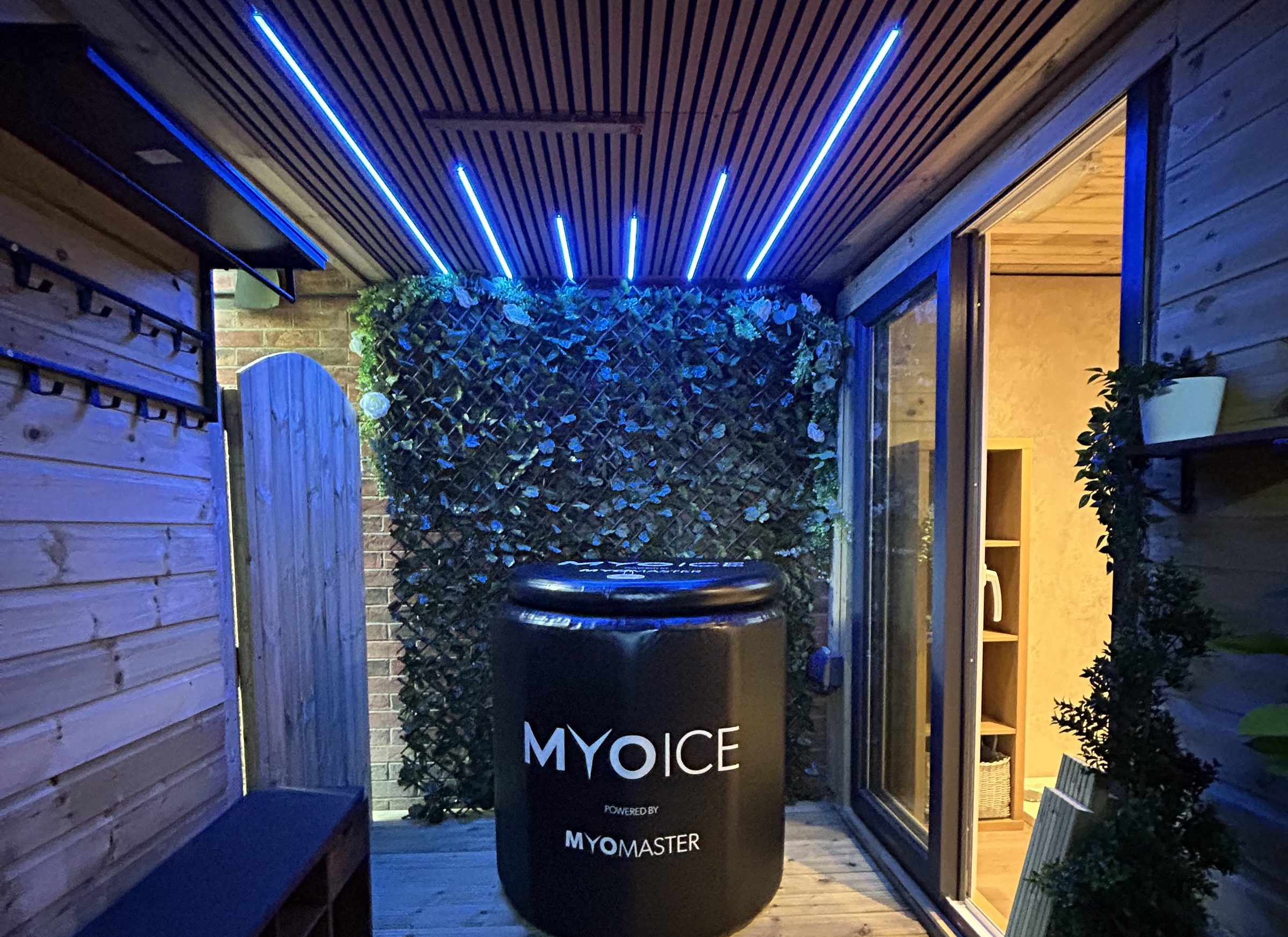 The Recovery Zone lodge at Masters Fitness, with blue ceiling lights, a living green wall and the MyoIce cold plunge