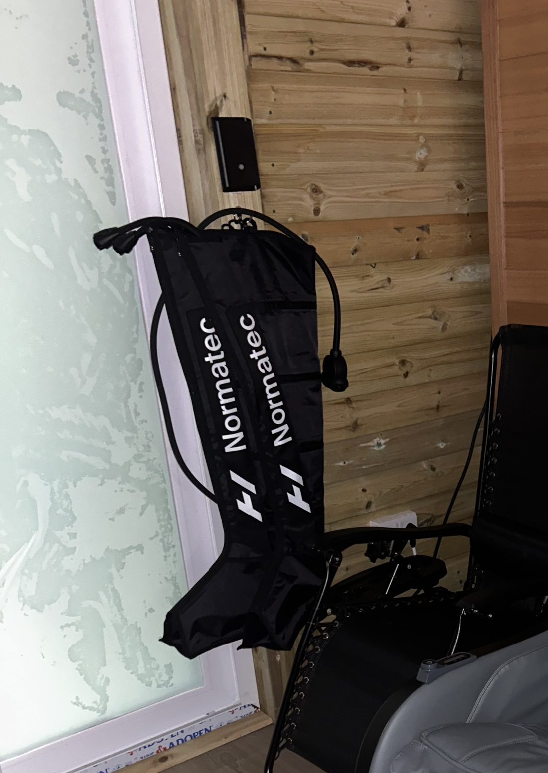 Normatec compression boots hanging on the wall of the Recovery Zone