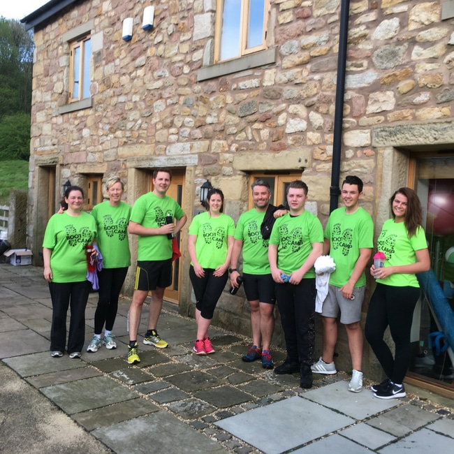 Masters Fitness members and coaches in matching t-shirts outside the gym